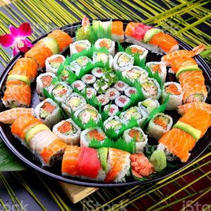 Rainbow Roll Tray: A colorful ensemble of fresh fish atop a California roll. (For 10 People)