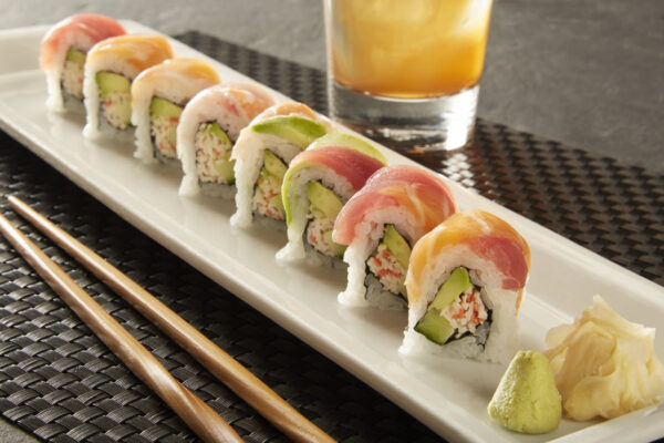 Rainbow Roll Tray: A colorful ensemble of fresh fish atop a California roll. (For 5 People)