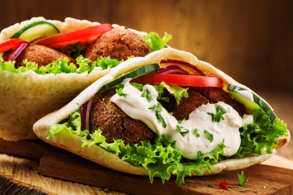 Falafel Wrap Lunch Box: Flavorful falafel bites wrapped in a soft pita with fresh veggies and tahini sauce.