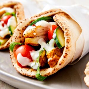 Chicken Shawarma Wrap Lunch Box: Mouthwatering chicken shawarma nestled in a pita with lettuce, tomato, and tahini sauce.